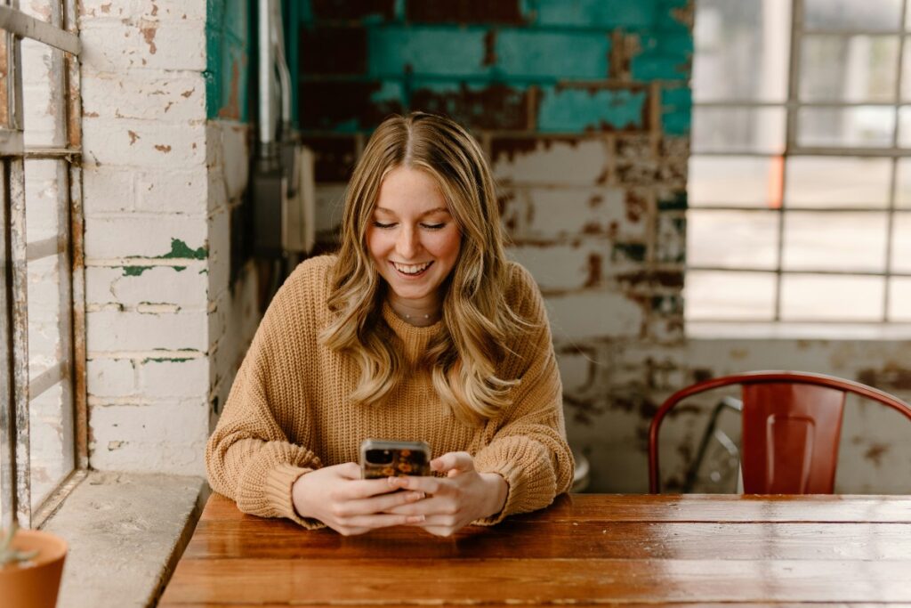 Borrower checking a loan account on a smartphone: Beyond the Payout: Keeping Borrowers Supported Until the Final Instalment