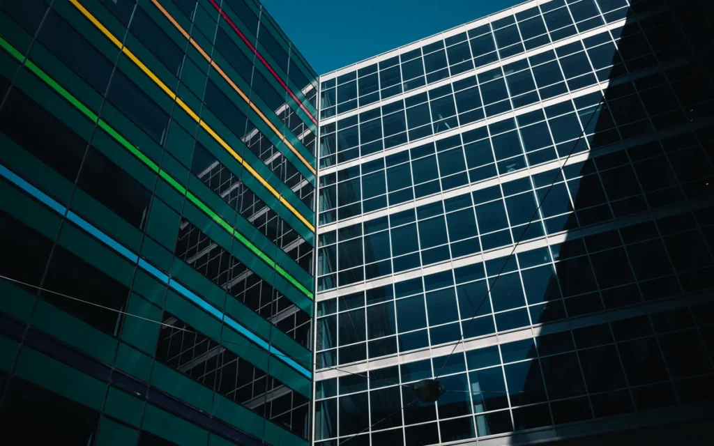 Architectural view of modern buildings with colorful stripes against a clear blue sky