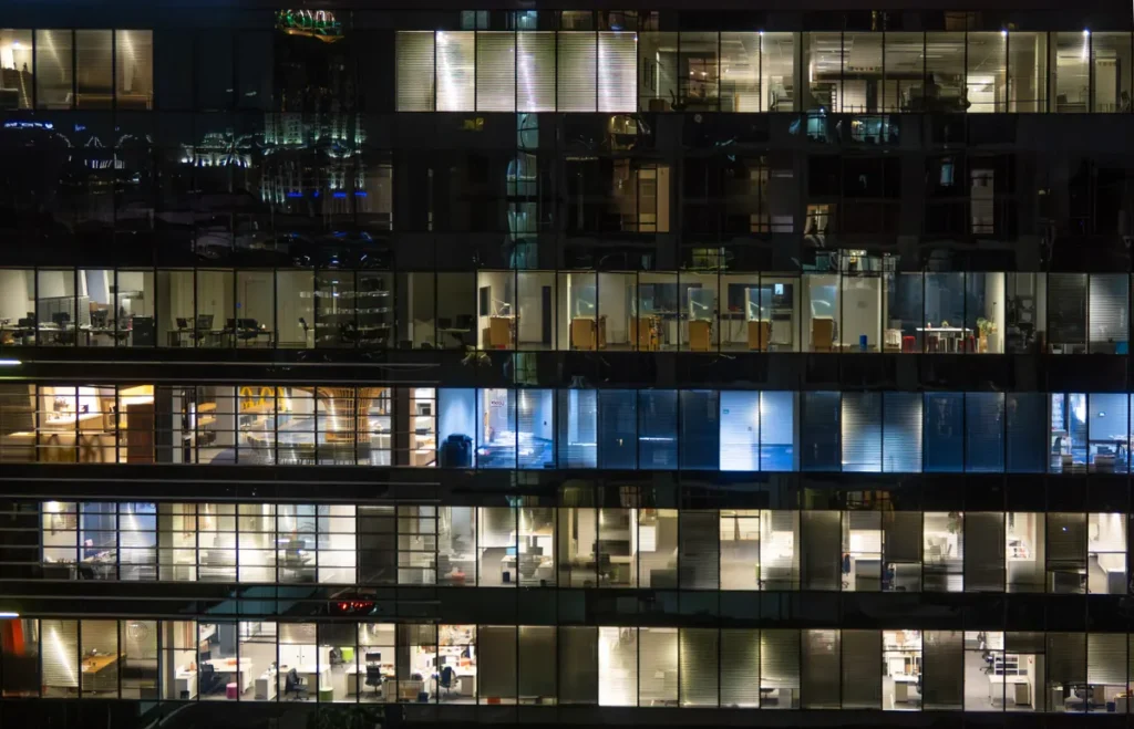 View of a city office building at night with illuminated floors showcasing modern architecture