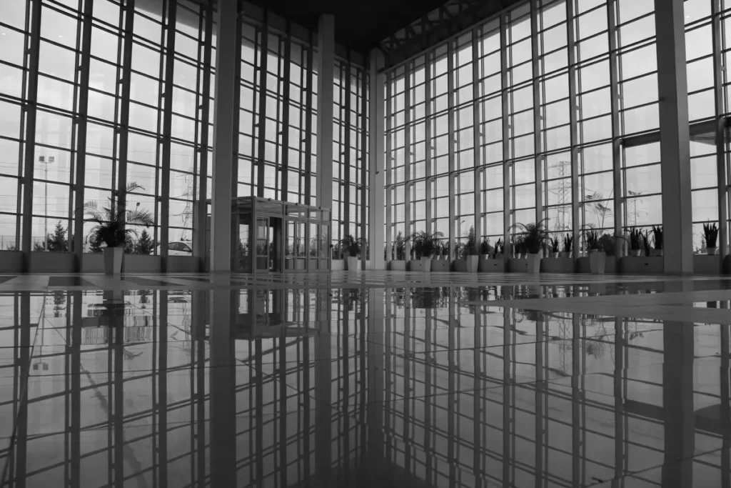 Spacious modern atrium with glass walls and polished reflections, exuding an urban architectural style