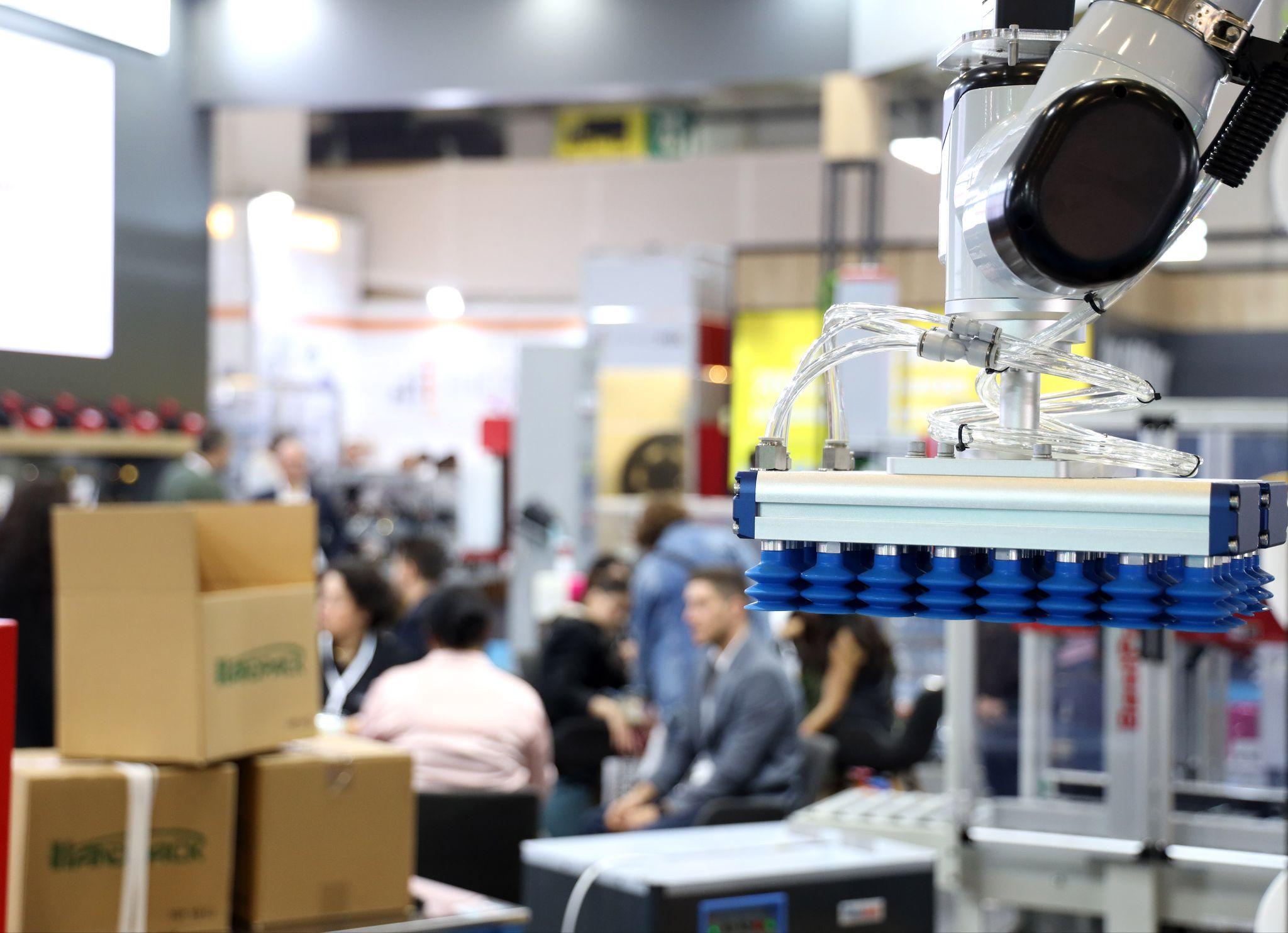 Packaging manufacturers and suppliers to gather at Eurasia Packaging Istanbul 2026: a robotic vacuum gripper lifting cartons on an exhibitor stand at Eurasia Packaging Istanbul