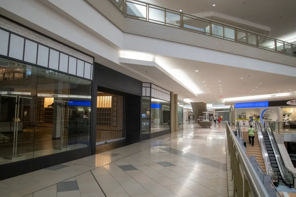 Retail sales fall sharper than forecast as consumer confidence slumps Spacious and contemporary mall interior with closed stores and escalator